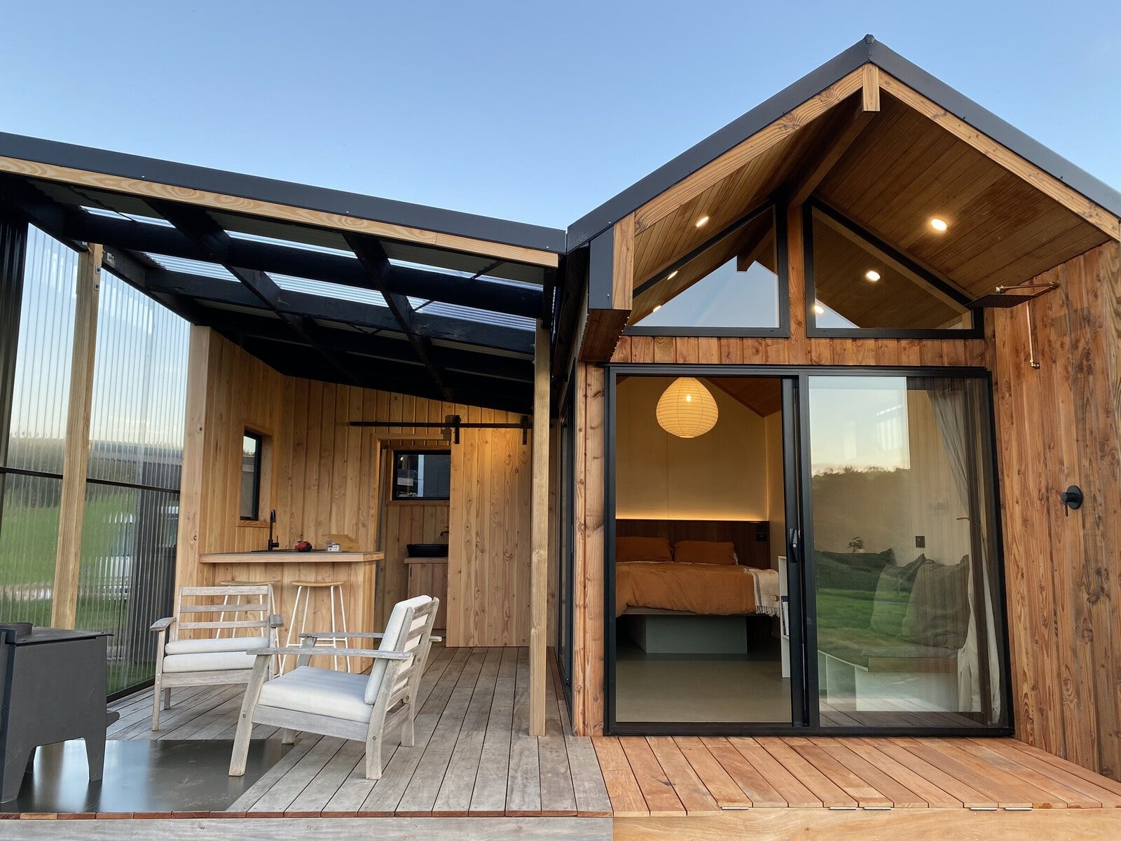 A stunning tiny house with an outdoor extension showcasing expanded living space