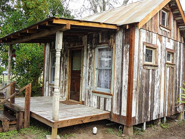 Rustic Farmhouse Tiny Home Decor. A tiny house interior featuring weathered wood walls and ceiling, with a cozy living area.