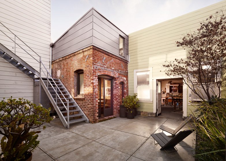 An interior shot of a tiny house featuring an exposed brick wall.
