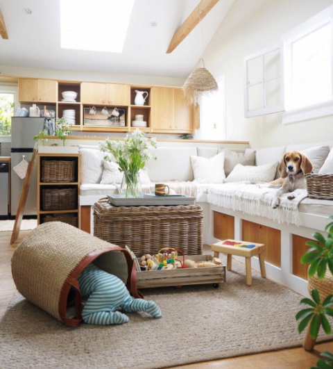 A family in a tiny house, showcasing clever storage solutions for toys.